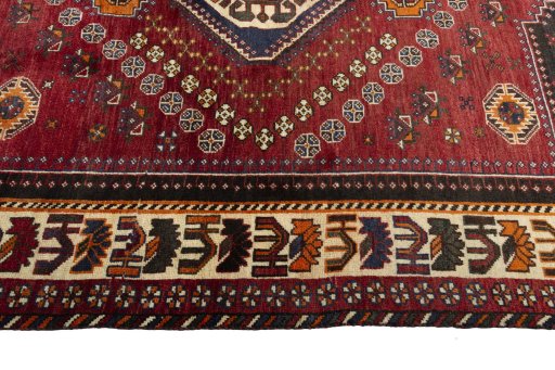 Corner detail of 2000s Shiraz rug showing border pattern and Wool pile
