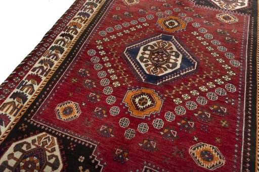 Backside of handmade 2000s Shiraz rug showing knot structure and weave density
