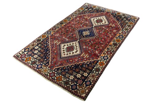 Corner detail of 2000s Shiraz rug showing border pattern and Wool pile