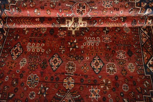 Corner detail of 2000s Shiraz rug showing border pattern and Wool pile