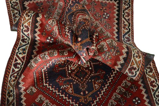 Corner detail of 2000s Shiraz rug showing border pattern and Wool pile