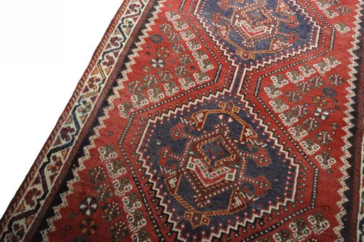 Backside of handmade 2000s Shiraz rug showing knot structure and weave density