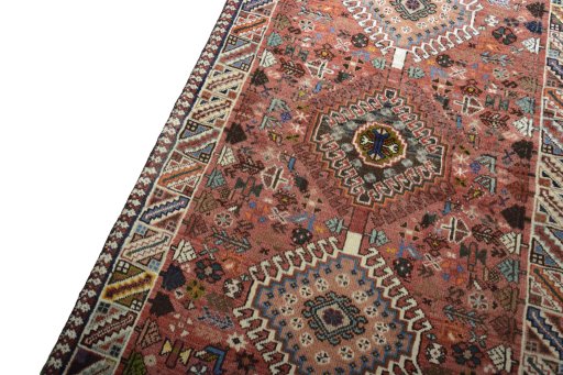 Backside of handmade 2000s Shiraz rug showing knot structure and weave density
