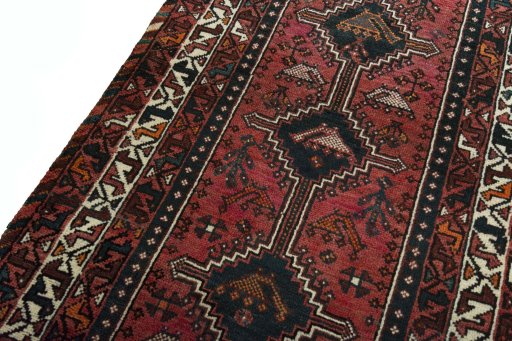 Backside of handmade 2000s Shiraz rug showing knot structure and weave density