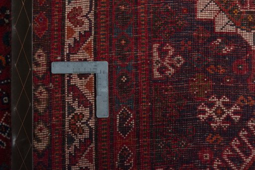 Backside of handmade 2000s Shiraz rug showing knot structure and weave density