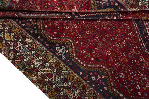 Corner detail of 2000s Shiraz rug showing border pattern and Wool pile