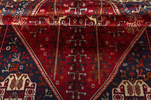 Corner detail of 2000s Shiraz rug showing border pattern and Wool pile