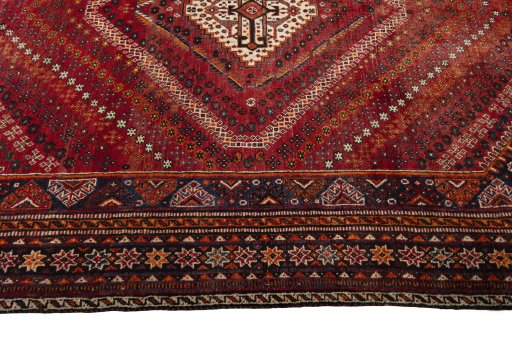 Corner detail of 2000s Shiraz rug showing border pattern and Wool pile