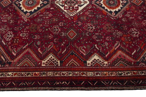 Corner detail of 2000s Shiraz rug showing border pattern and Wool pile