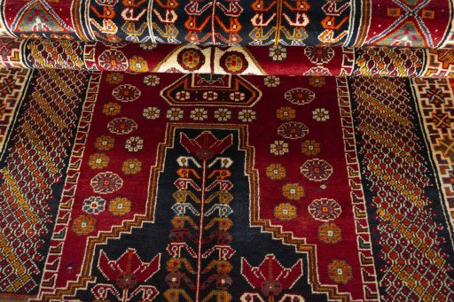 Corner detail of 2000s Shiraz rug showing border pattern and Wool pile