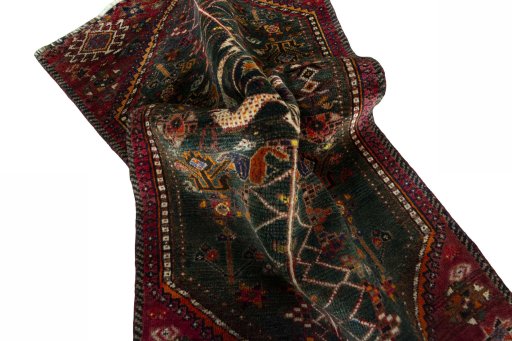 Corner detail of 2000s Shiraz rug showing border pattern and Wool pile