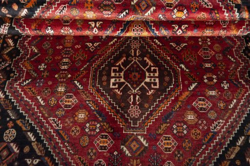 Corner detail of 2000s Shiraz rug showing border pattern and Wool pile