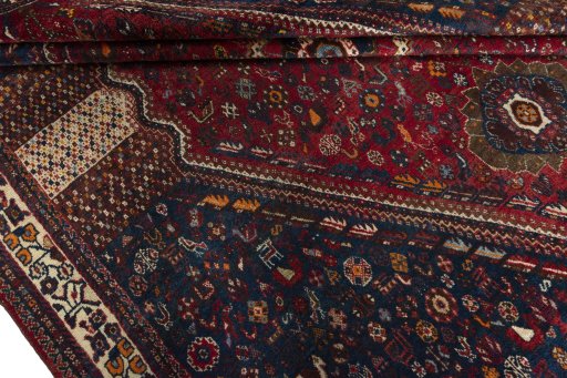 Full view of 1970s Shiraz rug from Iran / Persia, 286 × 220 cm in Red tones