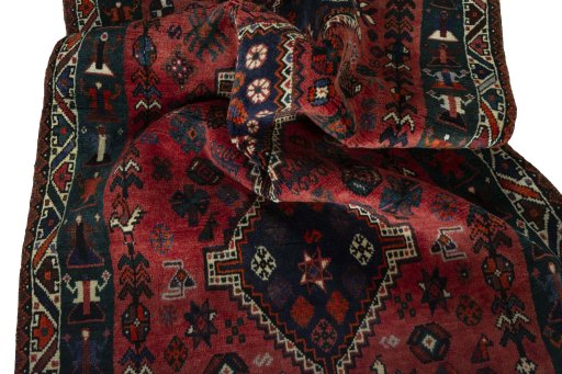 Corner detail of 2000s Shiraz rug showing border pattern and Wool pile