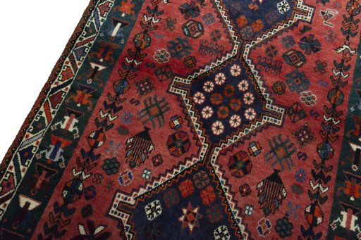 Backside of handmade 2000s Shiraz rug showing knot structure and weave density