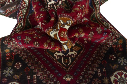 Corner detail of 2000s Shiraz rug showing border pattern and Wool pile