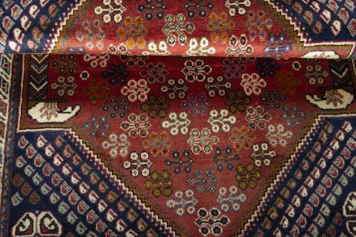 Corner detail of 2000s Shiraz rug showing border pattern and Wool pile