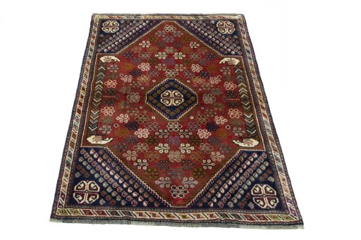 Surface texture of 2000s Shiraz rug with natural Wool and intricate pattern