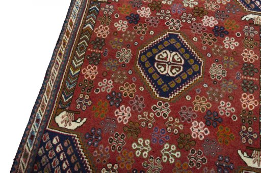 Backside of handmade 2000s Shiraz rug showing knot structure and weave density
