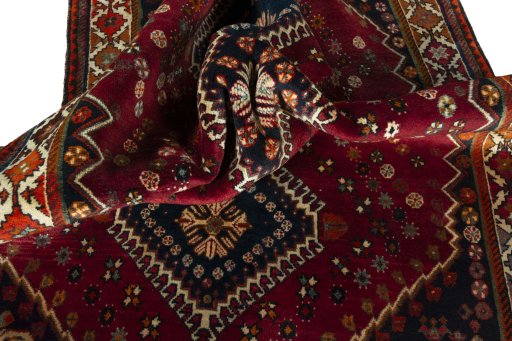 Corner detail of 2000s Shiraz rug showing border pattern and Wool pile