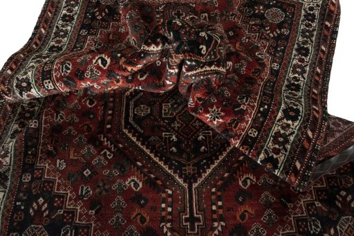 Corner detail of 2000s Shiraz rug showing border pattern and Wool pile