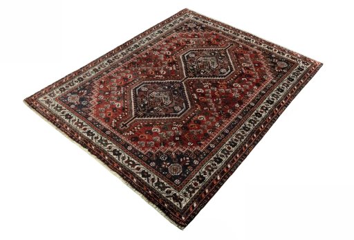 Corner detail of 2000s Shiraz rug showing border pattern and Wool pile
