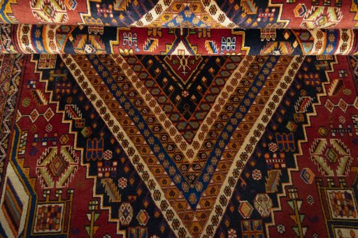 Corner detail of 2000s Shiraz rug showing border pattern and Wool pile