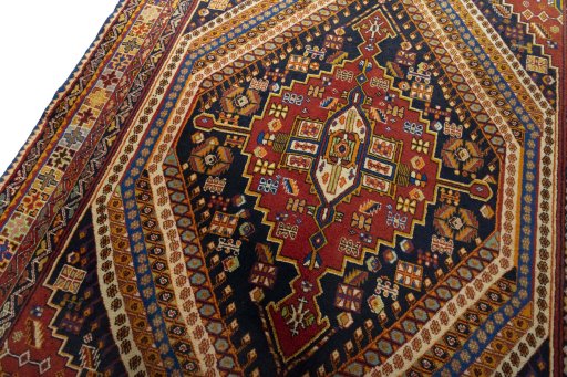 Backside of handmade 2000s Shiraz rug showing knot structure and weave density