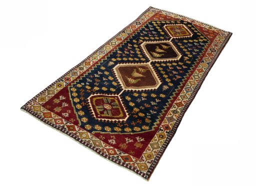 Corner detail of 2000s Shiraz rug showing border pattern and Wool pile
