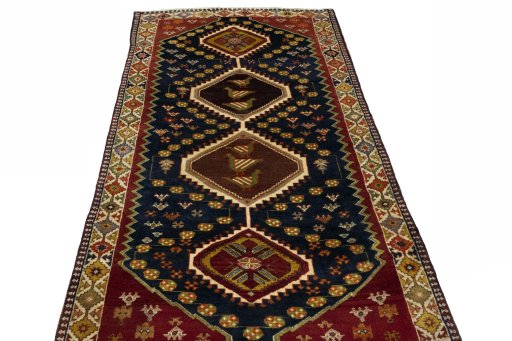 Surface texture of 2000s Shiraz rug with natural Wool and intricate pattern
