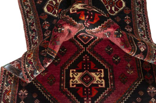 Corner detail of 2000s Shiraz rug showing border pattern and Wool pile