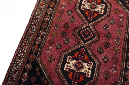 Backside of handmade 2000s Shiraz rug showing knot structure and weave density