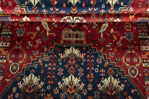 Corner detail of 2000s Shiraz rug showing border pattern and Wool pile