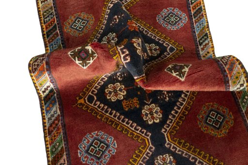 Corner detail of 2000s Shiraz rug showing border pattern and Wool pile