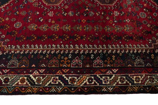 Corner detail of 2000s Shiraz rug showing border pattern and Wool pile
