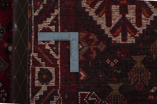 Backside of handmade 2000s Shiraz rug showing knot structure and weave density