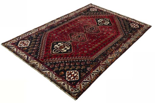 Corner detail of 2000s Shiraz rug showing border pattern and Wool pile