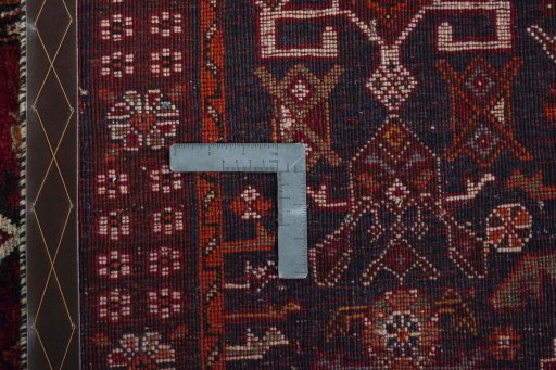 Surface texture of 2000s Shiraz rug with natural Wool and intricate pattern