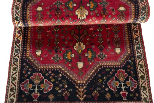 Corner detail of 2000s Shiraz rug showing border pattern and Wool pile