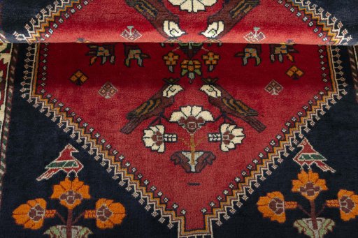 Corner detail of 2000s Shiraz rug showing border pattern and Wool pile