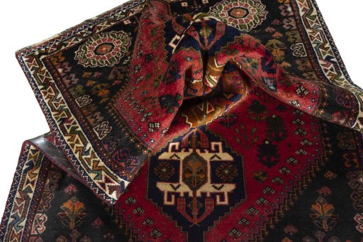 Corner detail of 2000s Shiraz rug showing border pattern and Wool pile