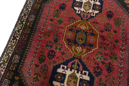 Backside of handmade 2000s Shiraz rug showing knot structure and weave density