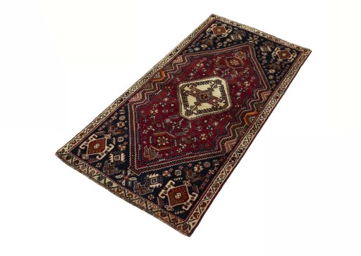 Corner detail of 2000s Shiraz rug showing border pattern and Wool pile