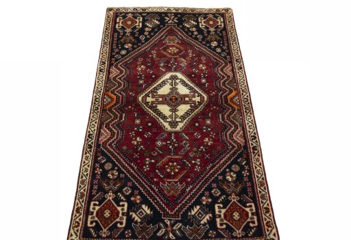 Surface texture of 2000s Shiraz rug with natural Wool and intricate pattern