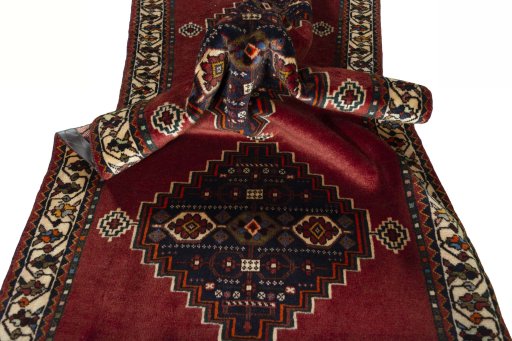 Corner detail of 2000s Shiraz rug showing border pattern and Wool pile