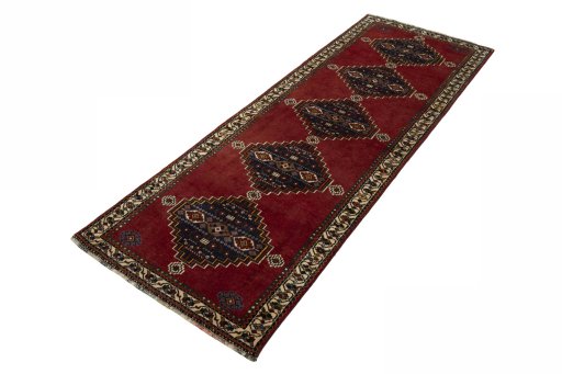 Corner detail of 2000s Shiraz rug showing border pattern and Wool pile