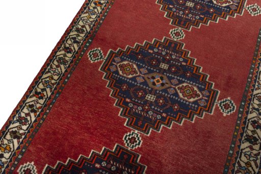 Backside of handmade 2000s Shiraz rug showing knot structure and weave density