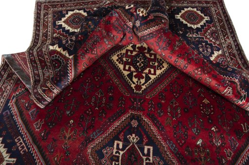 Corner detail of 2000s Shiraz rug showing border pattern and Wool pile