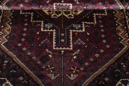 Corner detail of 2000s Shiraz rug showing border pattern and Wool pile