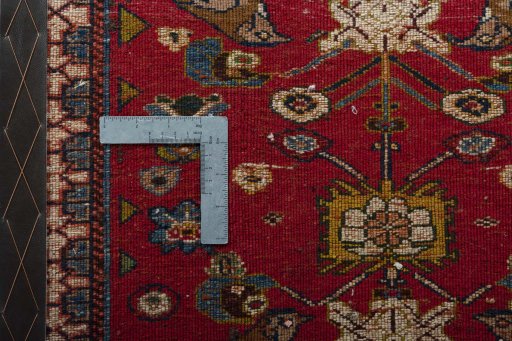 Backside of handmade 2000s Shiraz rug showing knot structure and weave density